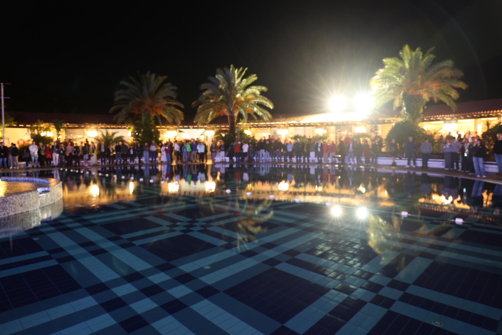 Evening lights reflected in the pool at the venue.